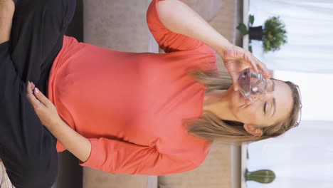 Vertical-video-of-The-woman-is-drinking-water.